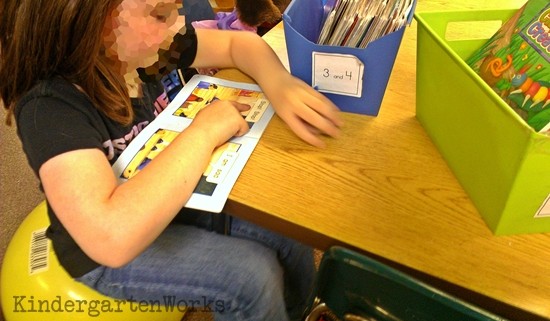 Kindergarten reading leveled books independently at literacy center