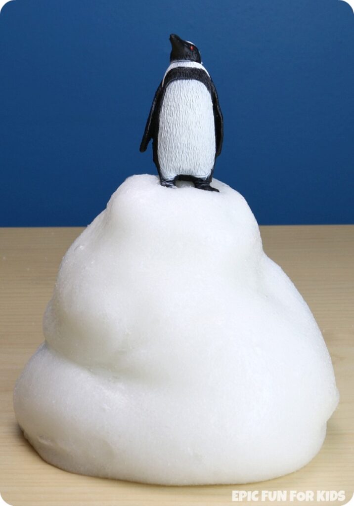 Penguin toy on top of white slime mountain